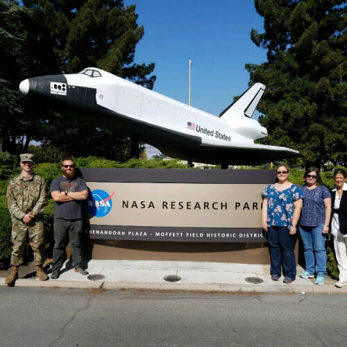 Kevin Maupin, second from left, is pictured at a NASA facility in Florida.